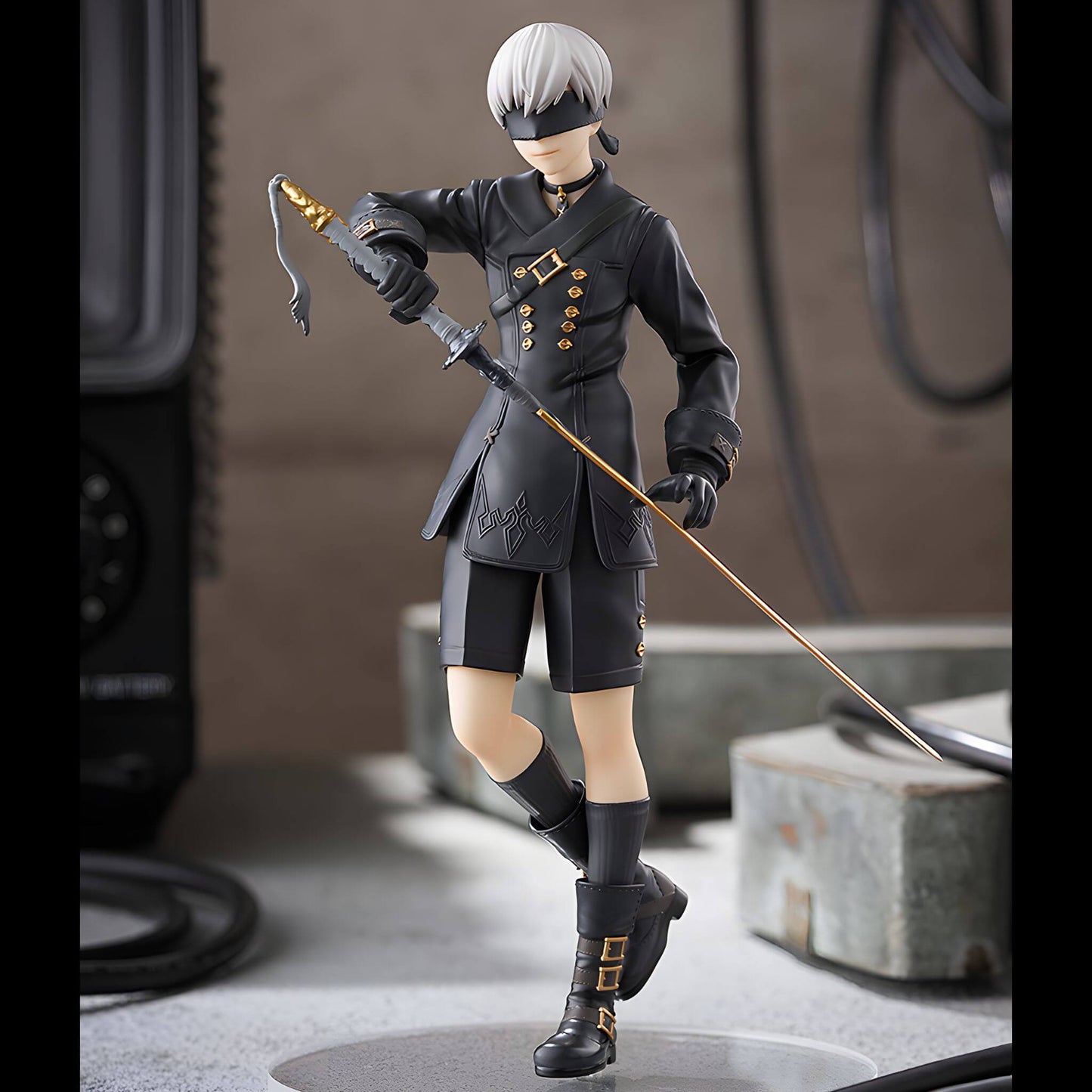 Good Smile Company NieR Automata Pop Up Parade 9S (YoRHa No.9 Type S) Figure in dark attire with a sword, standing on a concrete surface.