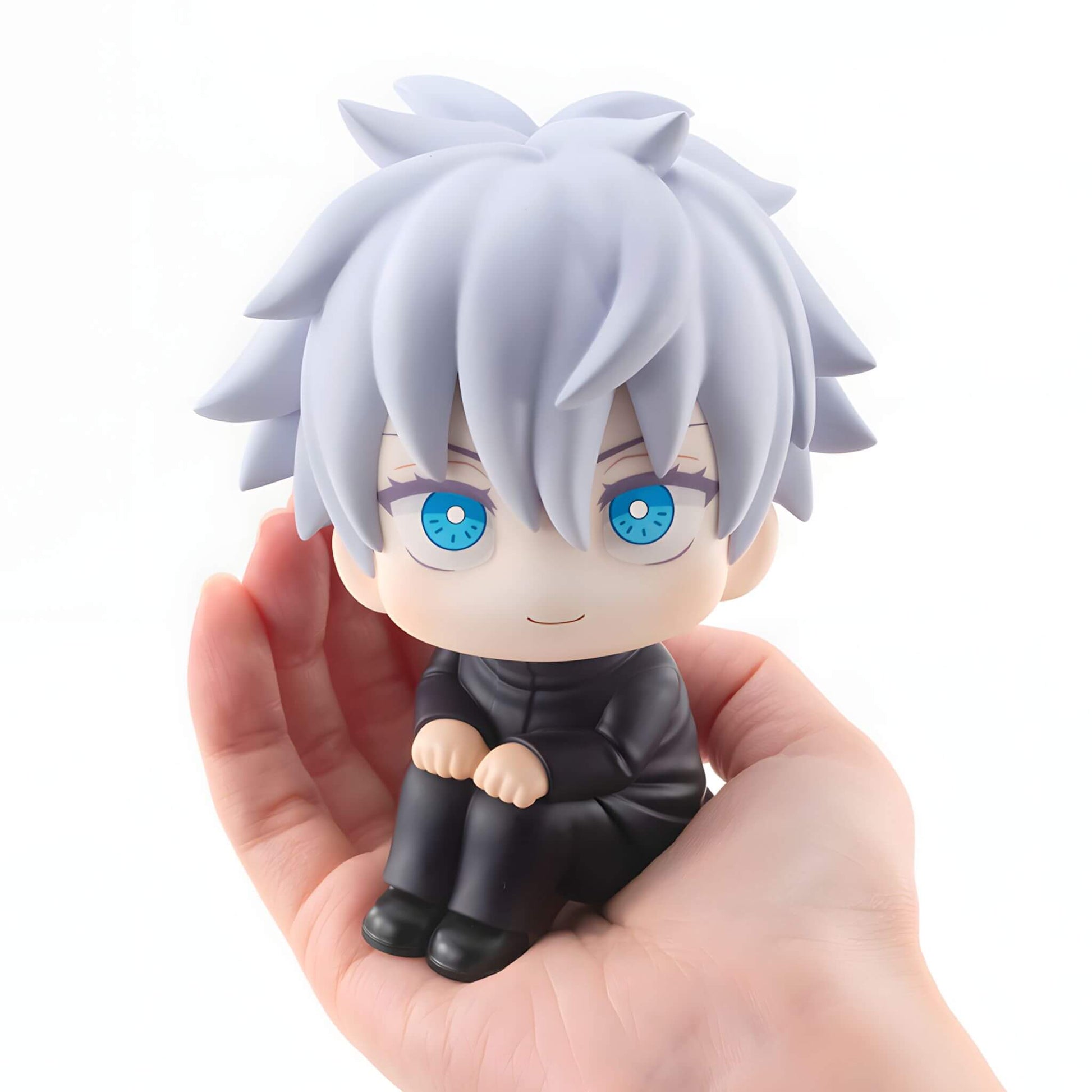 Megahouse Jujutsu Kaisen Look Up Series Satoru Gojo figurine with white hair and blue eyes held in a hand against a white background