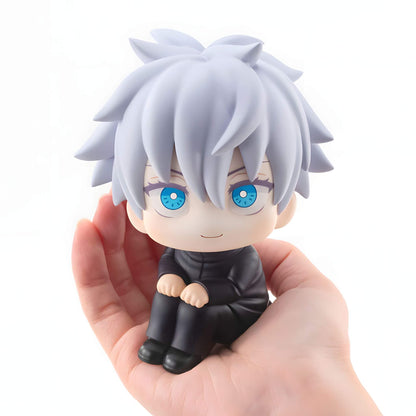 Megahouse Jujutsu Kaisen Look Up Series Satoru Gojo figurine with white hair and blue eyes held in a hand against a white background