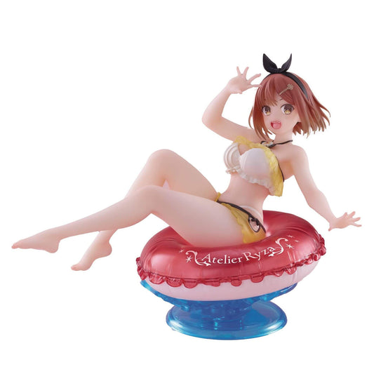 Figurine of anime character Ryza in a swimsuit sitting on a red inner tube with 'Atelier Ryza' branding.