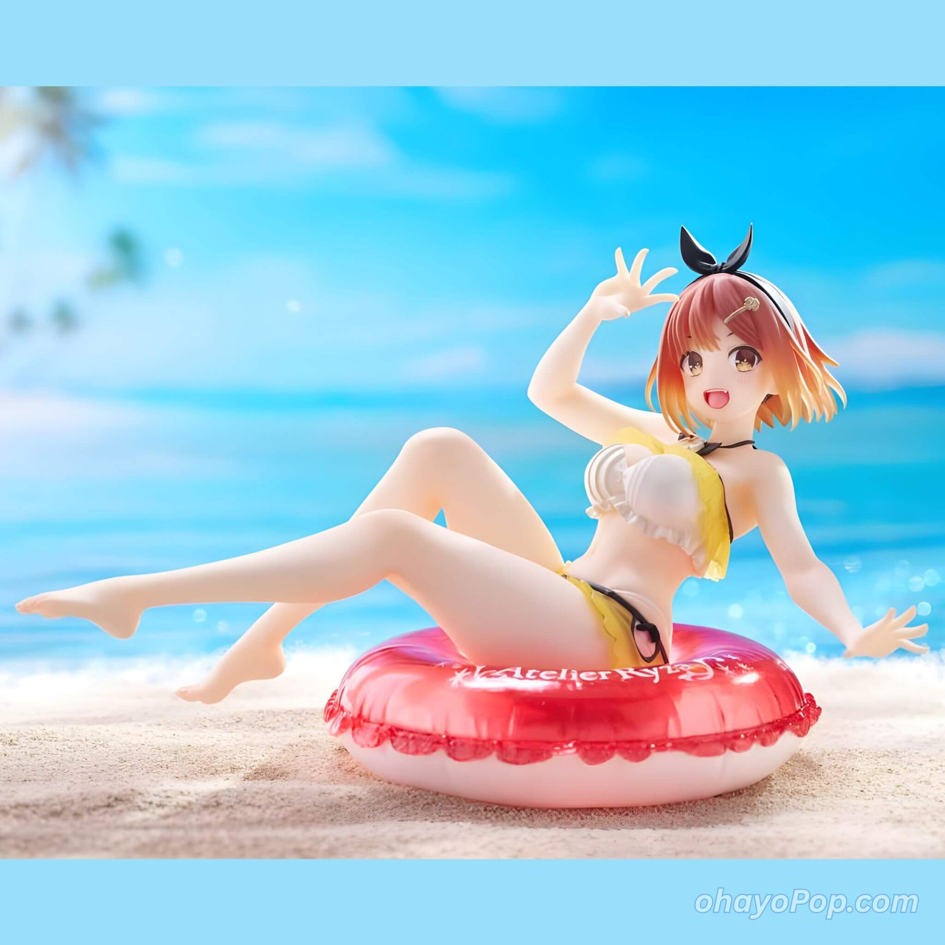 Anime character figurine of Ryza on a beach with a clear blue sky