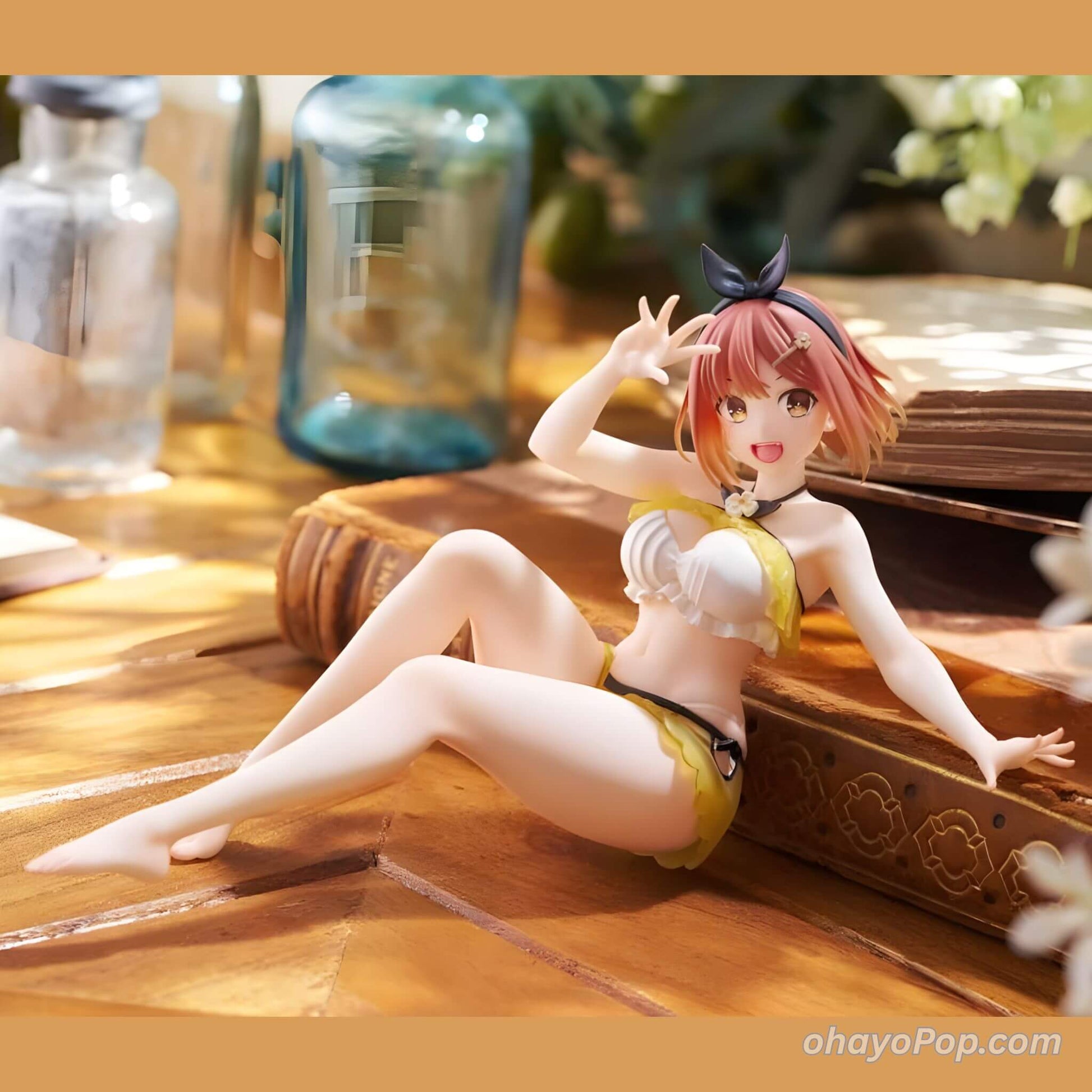 Anime figurine of Ryza on a wooden surface with books and a blurred background