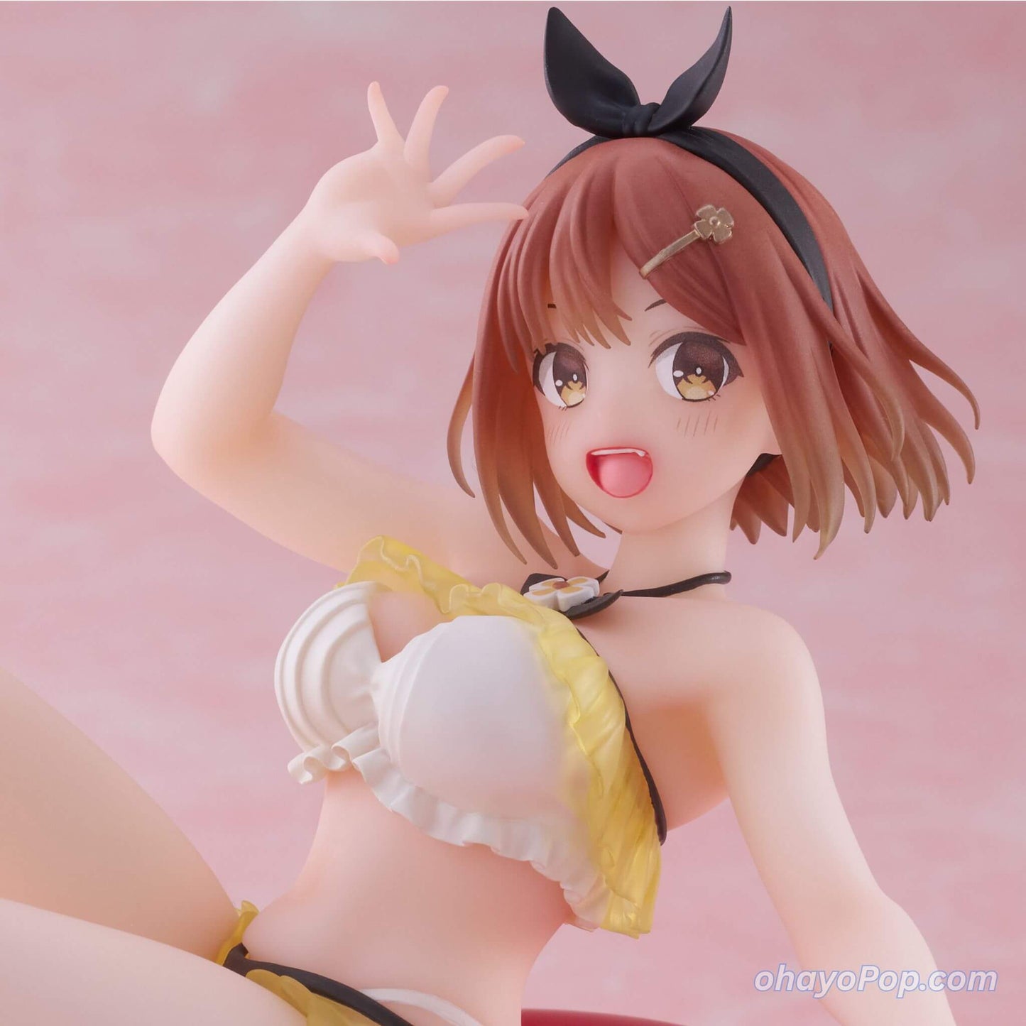 Close up look of Anime character figurine Ryza in a bikini with a pink background