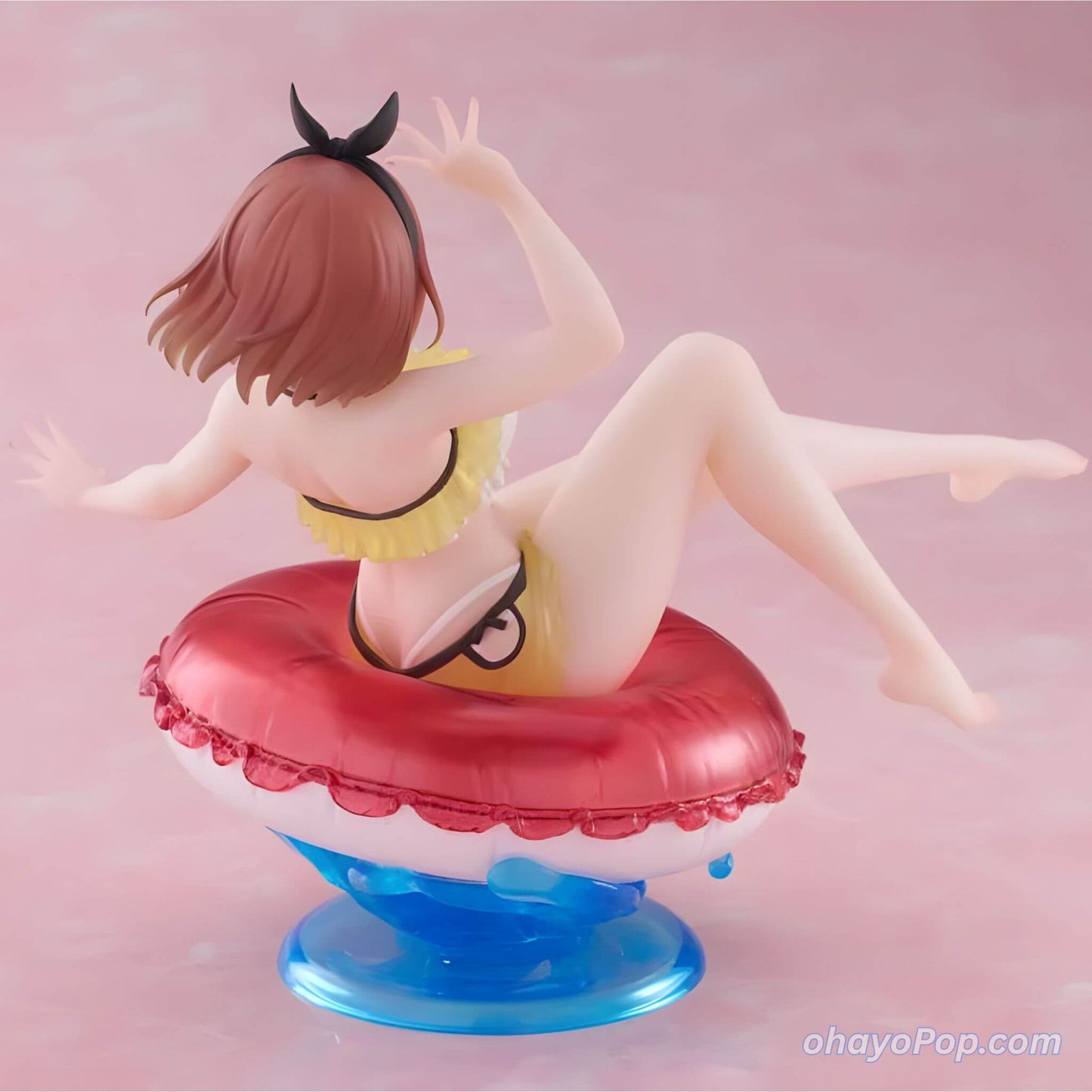 Back view of Figurine of an anime character Ryza in a swimsuit on a pink background