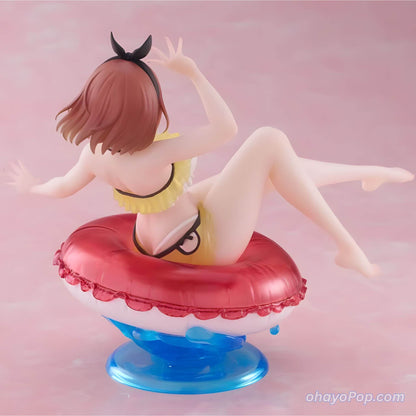 Back view of Figurine of an anime character Ryza in a swimsuit on a pink background