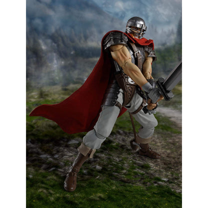 Berserk S.H.Figuarts Action figure of Guts in a fantasy setting with a red cape and armor, helmet, standing on a grassy field.