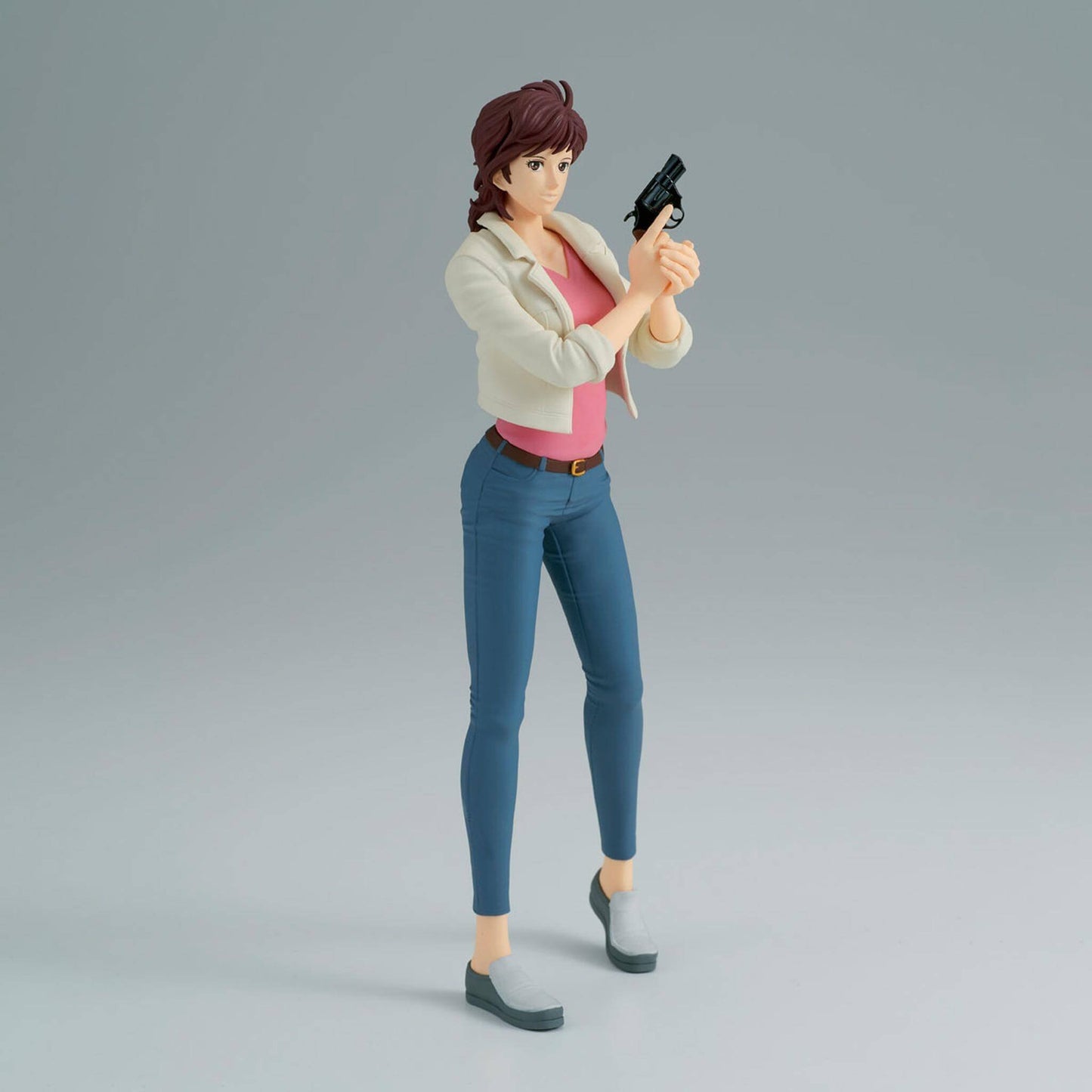 Side view of City Hunter anime figure of Kaori Makimura holding a gun on a gray background