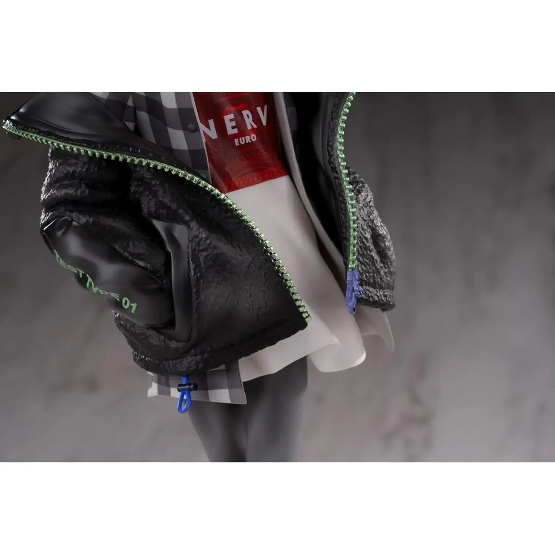 Close up view of Neon Genesis Evangelion 1/7 Scale Figure of Kaworu Nagisa wearing a black jacket with green zipper details on a neutral background