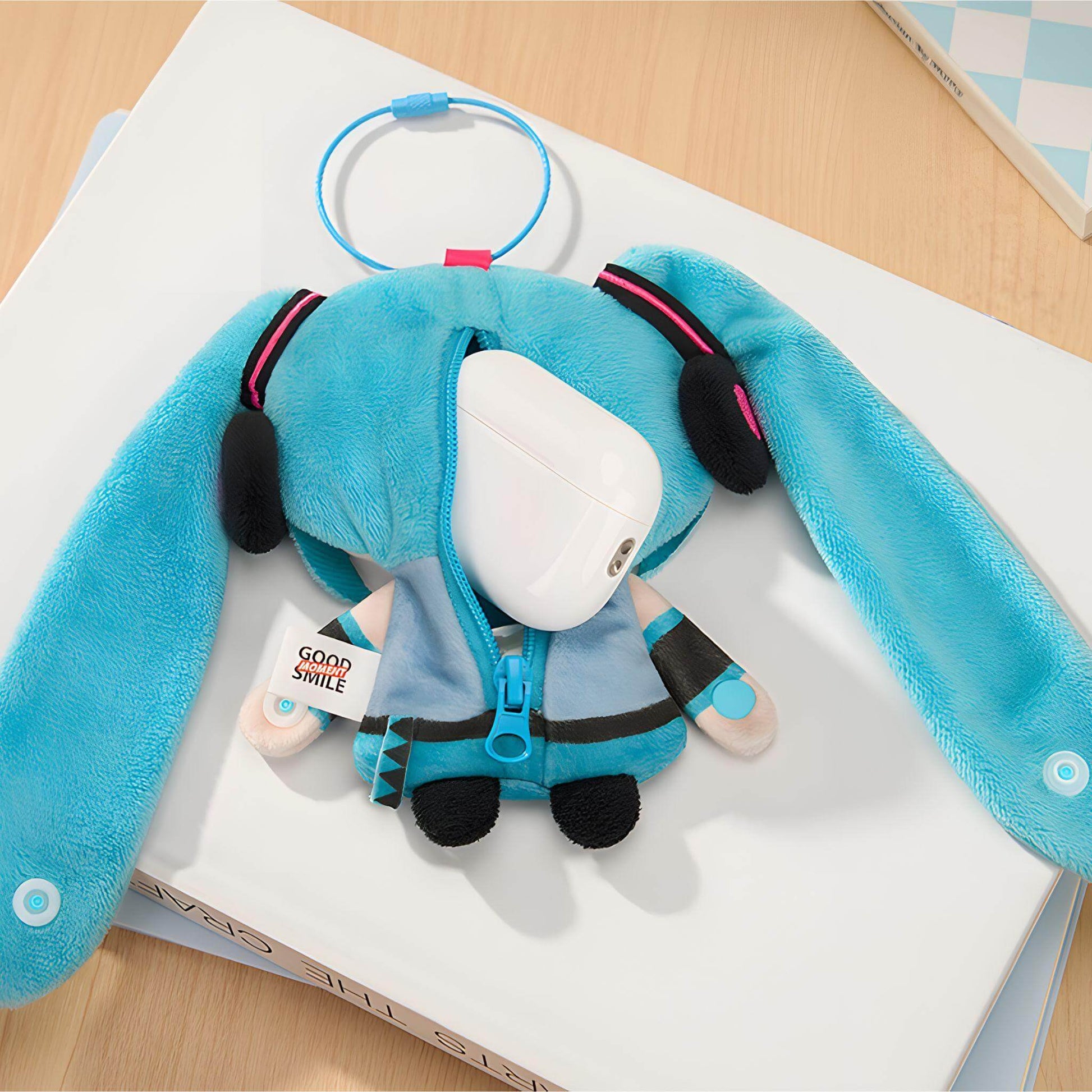 Hatsune Miku Keychain Pouch with a white face on a book