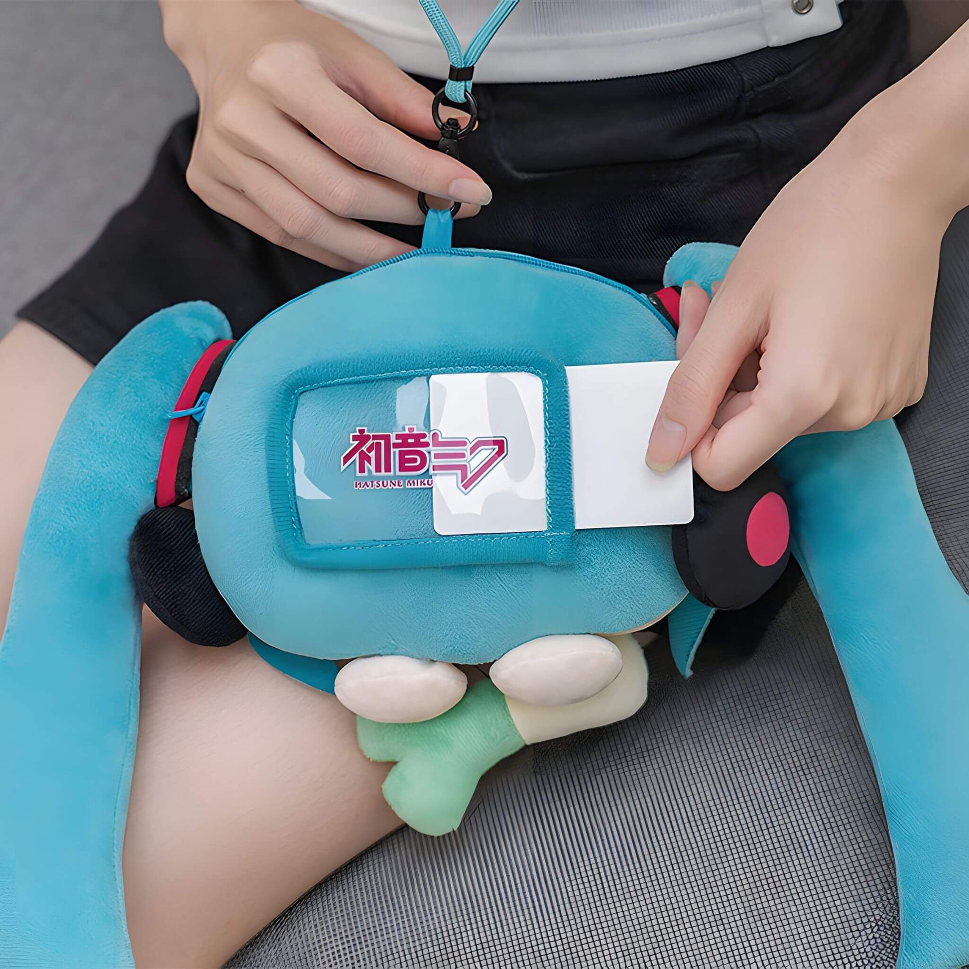 Hatsune Miku Plushie Pouch with character design held by a person