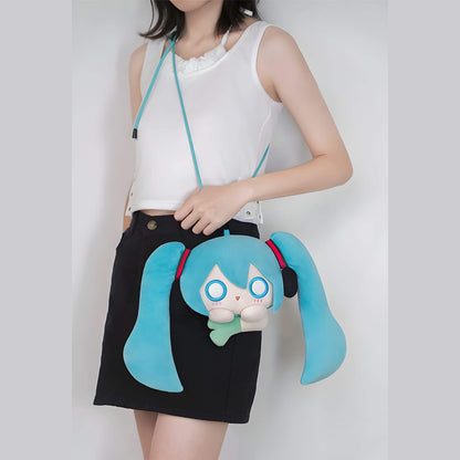 Person holding a Hatsune Miku Plushie Pouch with a character design on a plain background