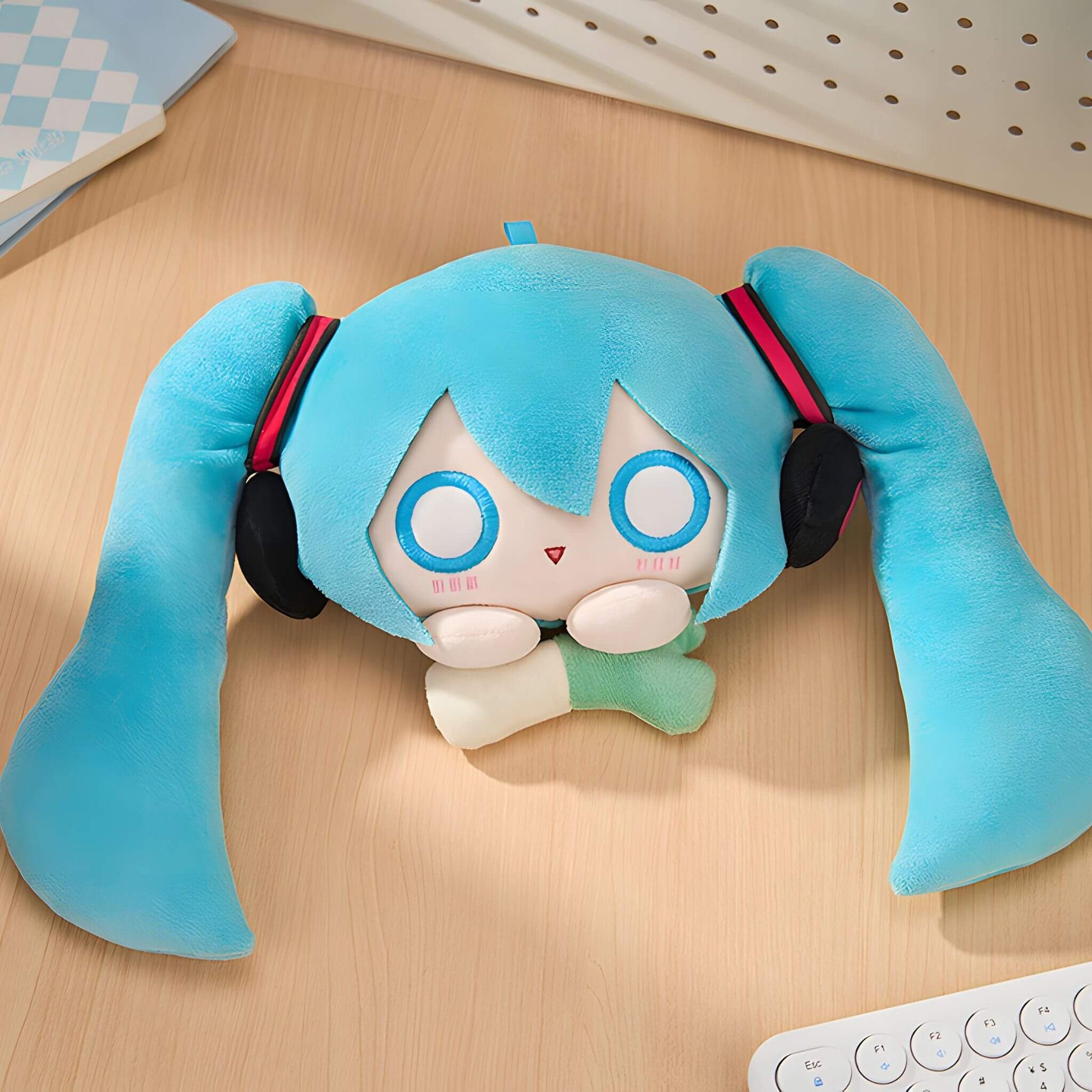 Hatsune Miku Plushie Pouch with blue hair and headphones on a wooden surface