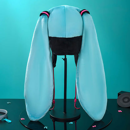 Hatsune Miku Character Hat with long white hair on a stand against a teal background