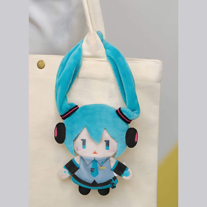 Hatsune Miku Keychain Pouch with blue hair and headphones hanging from a beige bag.