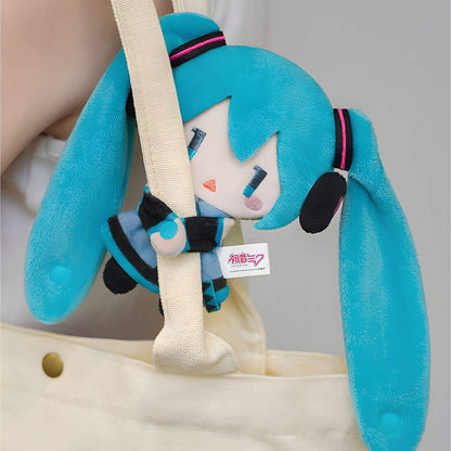 Hatsune Miku Keychain Pouch with blue hair and a white face, attached to a beige bag.