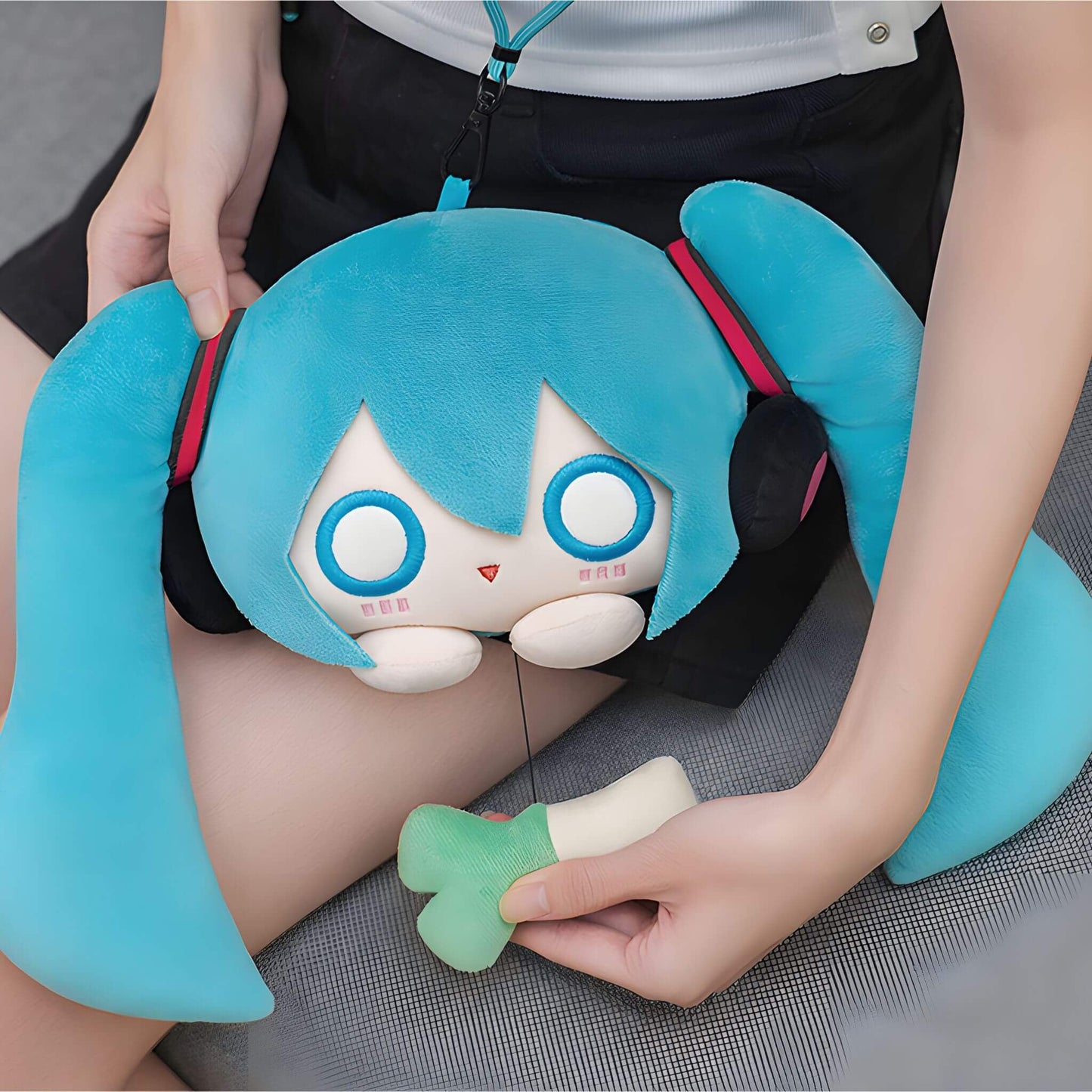 Hatsune Miku Plushie Pouch with character design held by a person