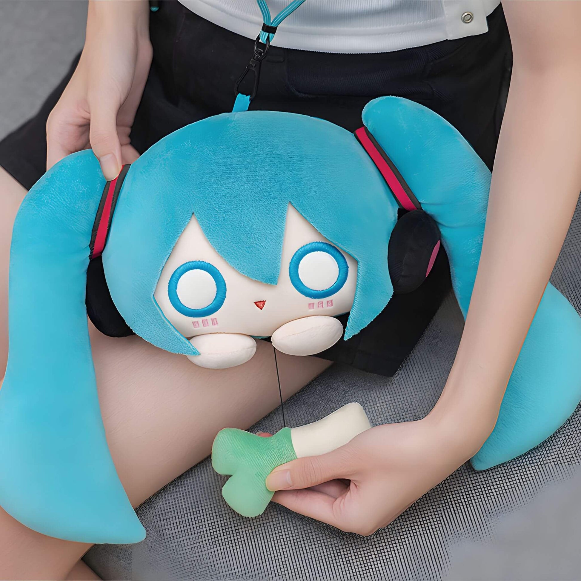 Hatsune Miku Plushie Pouch with character design held by a person
