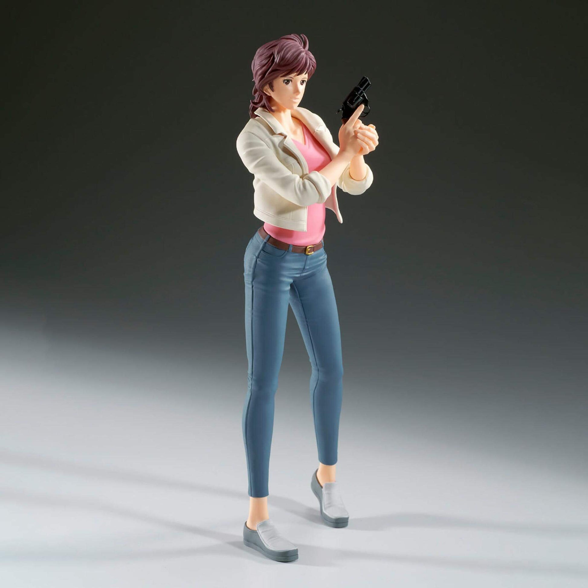 Side view of City Hunter anime figure of Kaori Makimura holding a gun on a gray background with depth