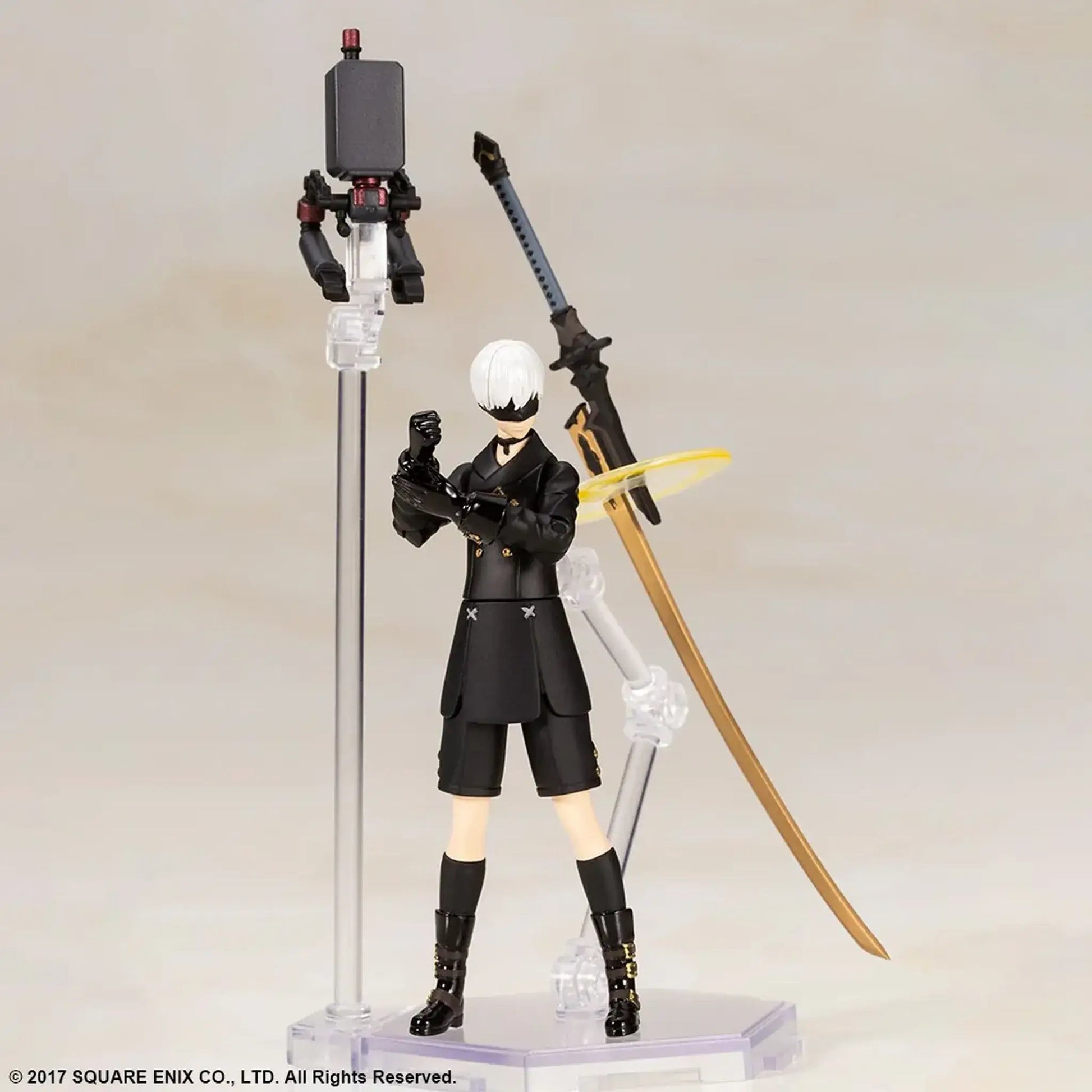 9S Action figure with a sword and pod on a stand against a plain background