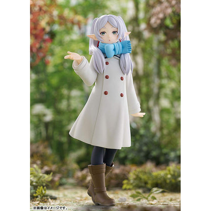Frieren Blow Kiss Pop Up Parade figure in a white coat with red buttons, blue scarf, and brown boots against a natural background.