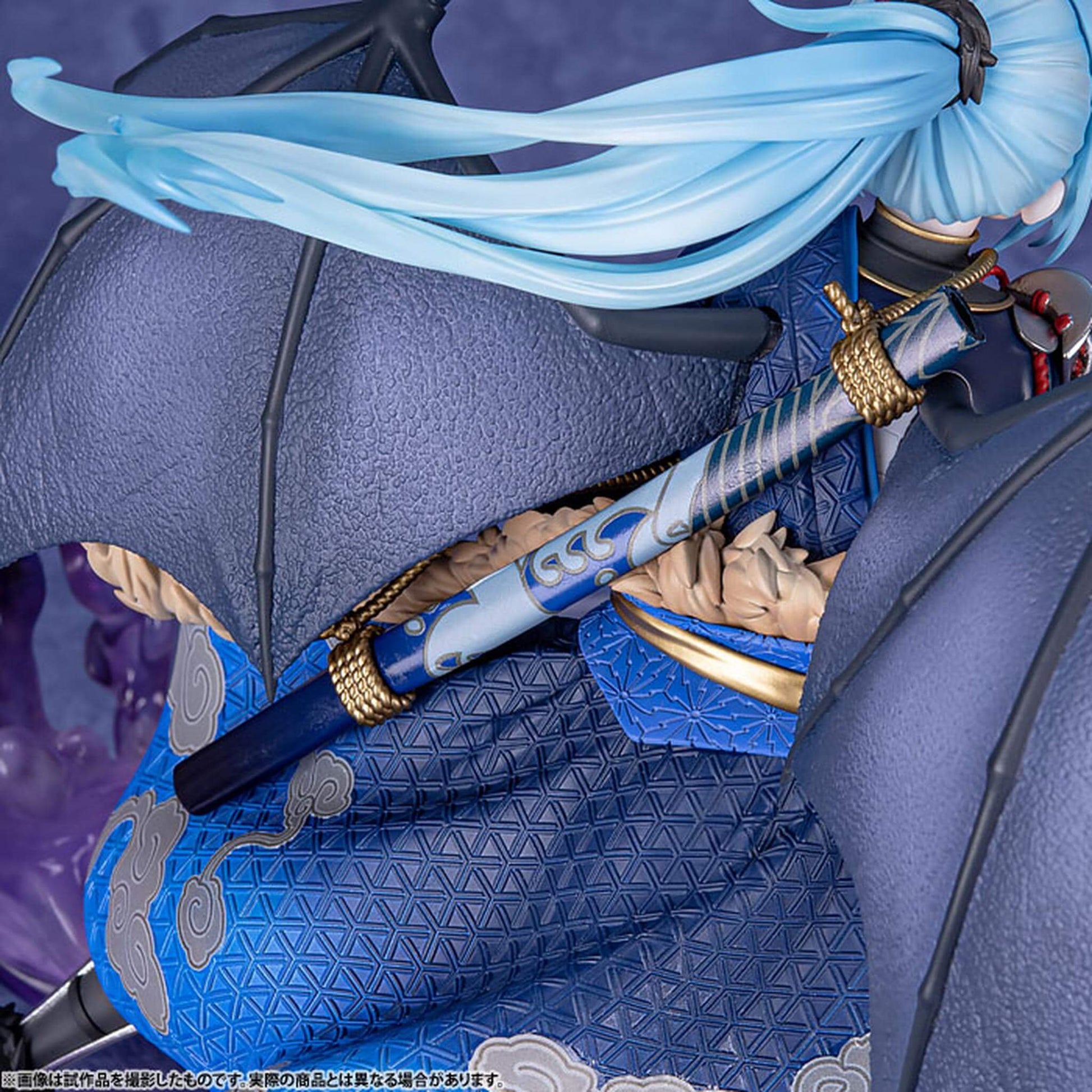 Close-up back view of That Time I Got Reincarnated as a Slime Figurine of Rimuru Tempest  with blue hair and traditional attire holding a sword.