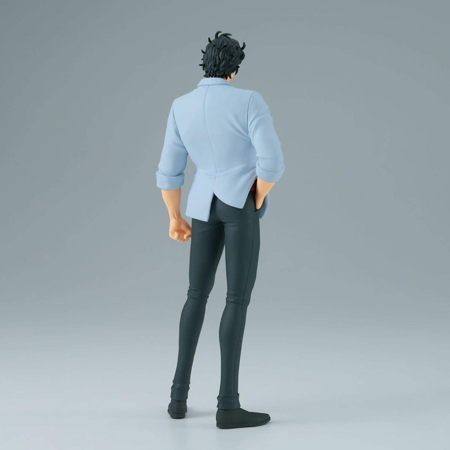 Back view of an anime figure of Ryo Saeba wearing a light blue shirt and black pants on a gray background
